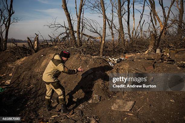 Pro-Russian rebel walks through an overrun Ukrainian check point that was destroyed approximately one month ago as rebels marched towards Debaltseve...