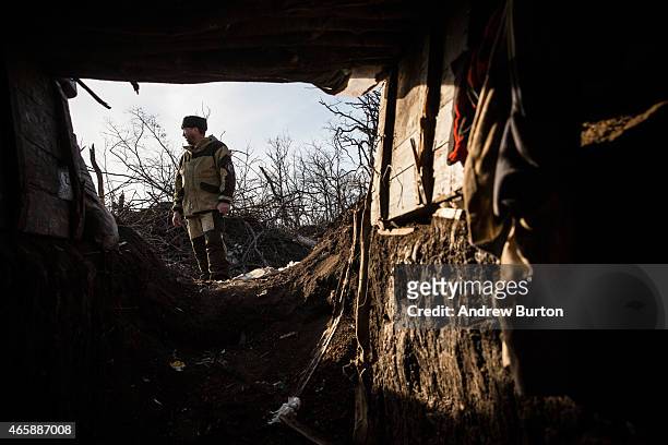 Pro-Russian rebel walks through an overrun Ukrainian check point that was destroyed approximately one month ago as rebels marched towards Debaltseve...