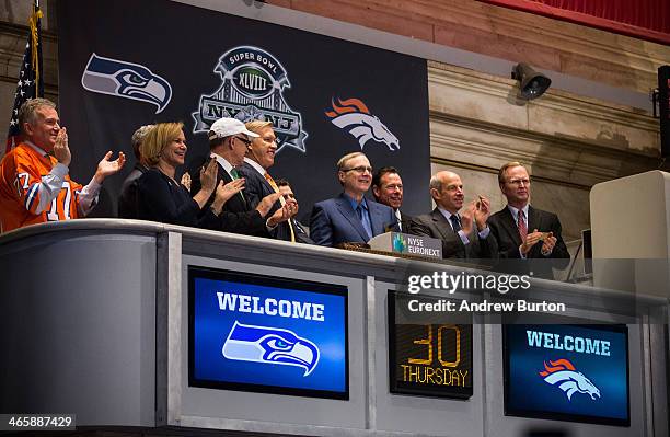 Members of the Super Bowl Host Committee, along with owners and managers of the Denver Broncos and Seattle Seahawks ring the opening bell of the New...