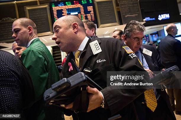 Traders work on the floor of the New York Stock Exchange on the morning of January 30, 2014 in New York City. The NYSE welcomed members of the Super...