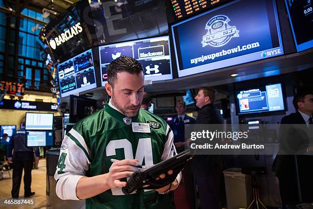 Trader works on the floor of the New York Stock Exchange on the morning of January 30, 2014 in New York City. The NYSE welcomed members of the Super...