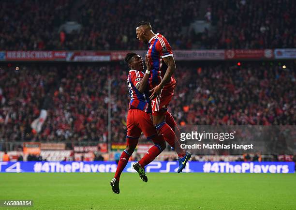 Jerome Boateng of Bayern Muenchen celebrates with David Alaba as he scores their second goal during the UEFA Champions League Round of 16 second leg...