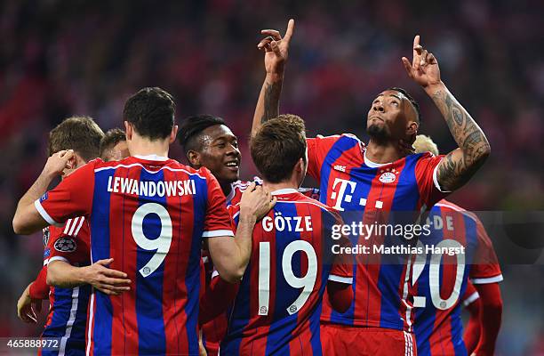 Jerome Boateng of Bayern Muenchen celebrates with team mates as he scores their second goal during the UEFA Champions League Round of 16 second leg...