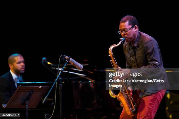 American Jazz musician Ravi Coltrane plays tenor saxophone with pianist Jason Moran at the Blue Note Records 75th Anniversary Concert during the 2014...