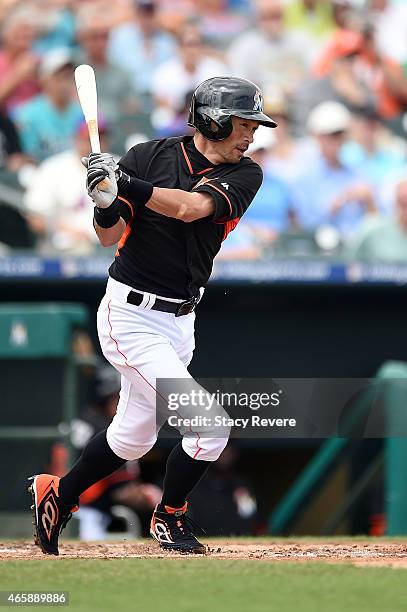 Ichiro Suzuki of the Miami Marlins swings at a pitch during the second inning of a spring training game against the New York Mets at Roger Dean...