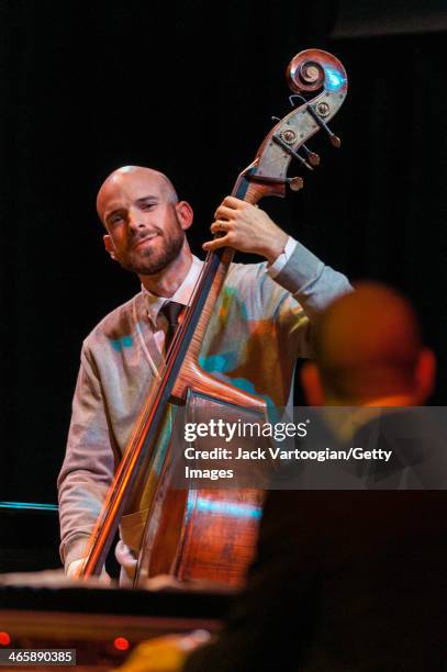 American musician Alan Hampton plays upright acoustic bass with pianist Jason Moran at the Blue Note Records 75th Anniversary Concert during the 2014...