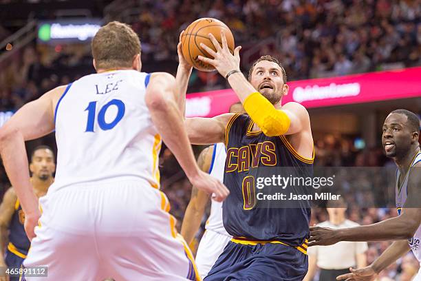 David Lee of the Golden State Warriors guards Kevin Love of the Cleveland Cavaliers during the second half at Quicken Loans Arena on February 26,...