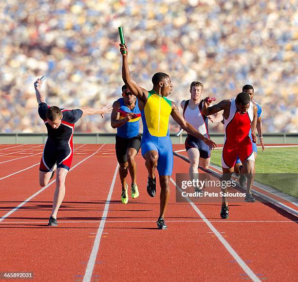 six athletes running relay race - teamevenement stockfoto's en -beelden