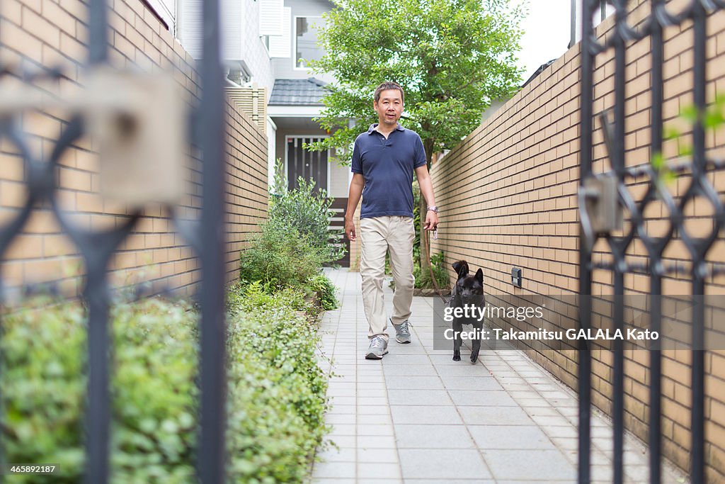 Man walking his pet dog