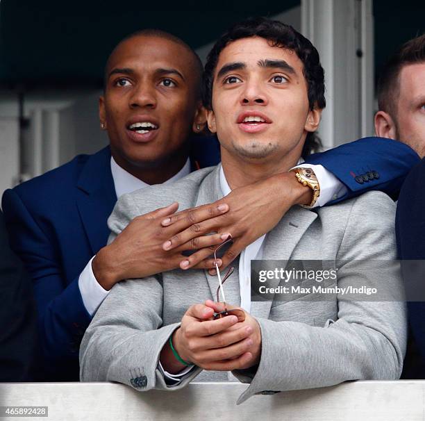 Manchester United players Ashley Young and Rafael da Silva watch the racing as they attend day 2 of the Cheltenham Festival at Cheltenham Racecourse...