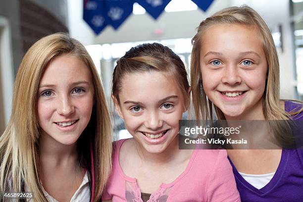 close up portrait of three teen and pre-adolescent girls smiling - hazel bond fotografías e imágenes de stock