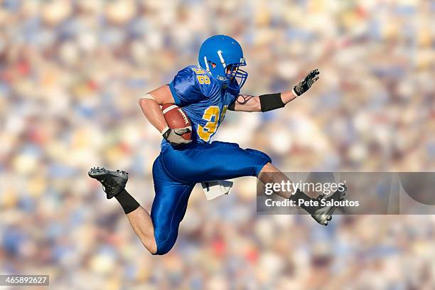 american footballer jumping with ball - american football player stock pictures, royalty-free photos & images
