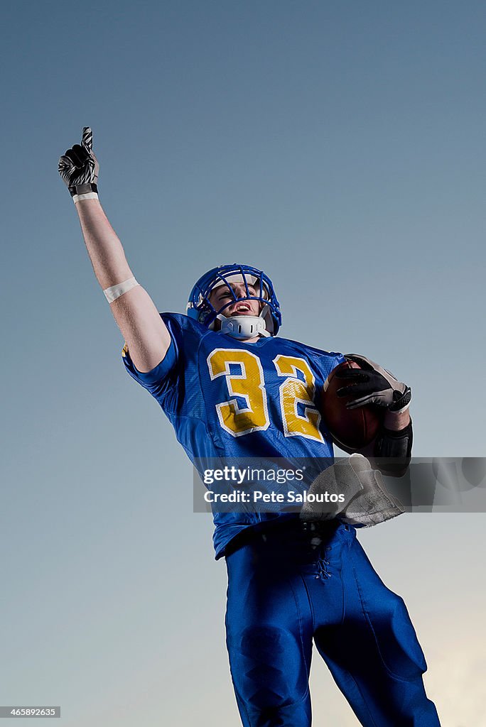 American footballer pointing towards sky