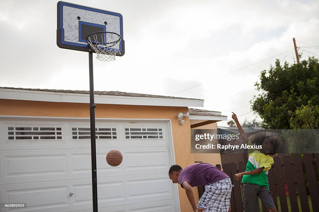 Two brothers playing basketball