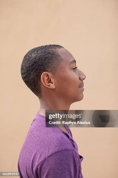 portrait of boy wearing purple t-shire, side view - 剃った頭 ストックフォトと画像