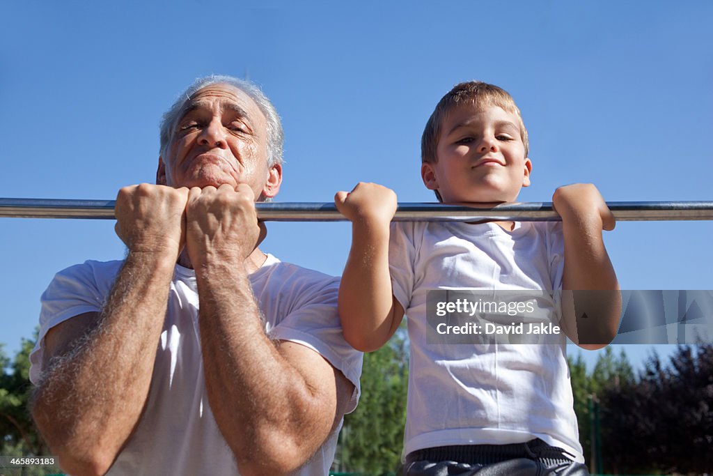 Man and grandson doing chin-ups