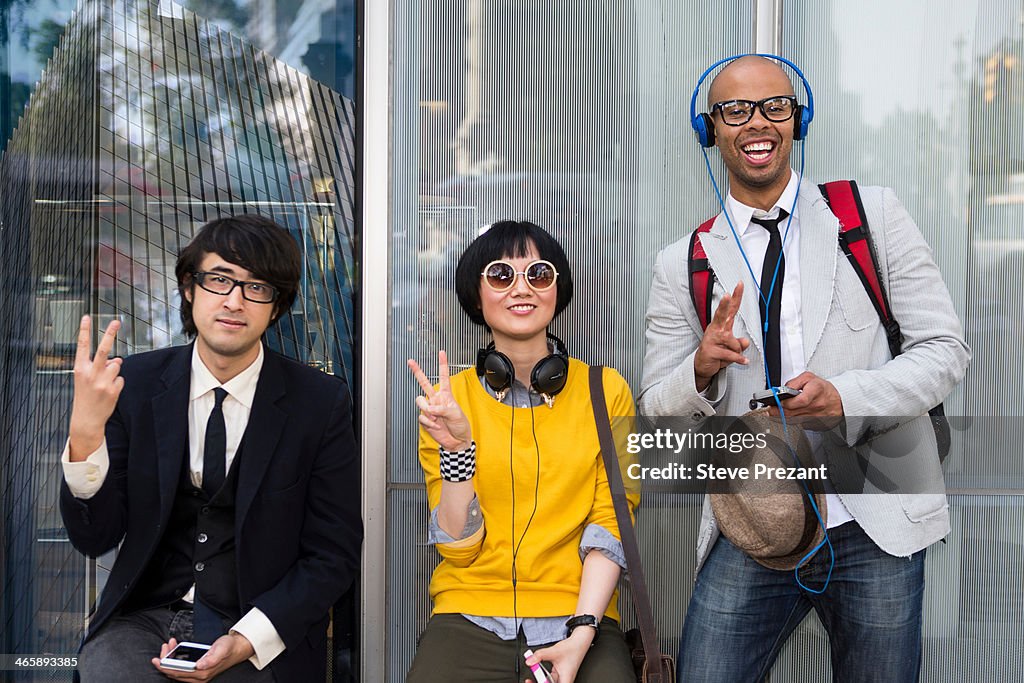 Three friends making victory sign