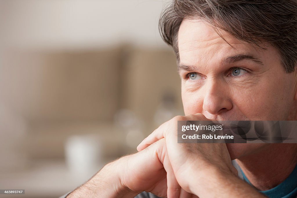 Portrait of mature man with hands on chin