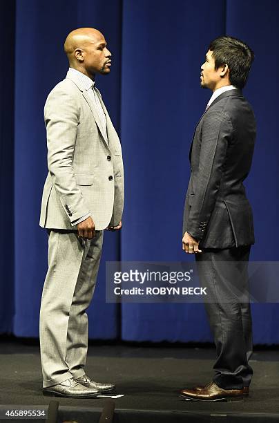 Boxers Floyd Mayweather Jr from the US and Manny Pacquiao from the Philippines face each other during a press conference on March 11, 2015 at the...