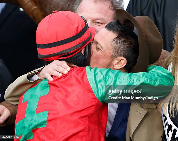 Sam Twiston-Davies kisses Frankie Dettori after winning the Queen Mother Champion Steeple Chase on day 2 of the Cheltenham Festival at Cheltenham...