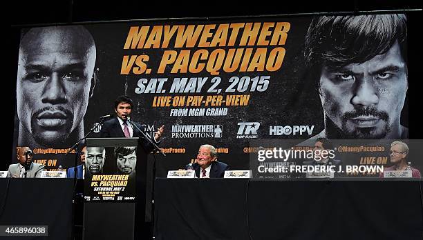 Boxers Manny Pacquiao from the Philippines speaks as Floyd Mayweather Jr from the US looks on during a press conference on March 11, 2015 in Los...