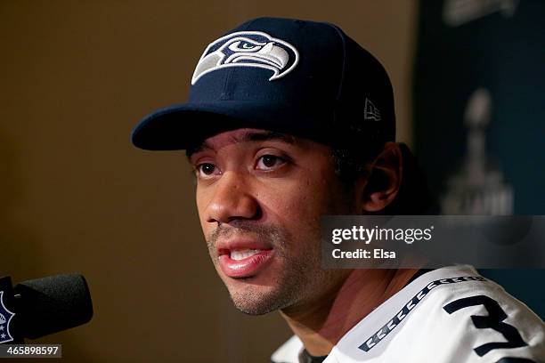 Russell Wilson of the Seattle Seahawks addresses the media during Super Bowl XLVIII media availability at the Westin Hotel January 30, 2014 in Jersey...