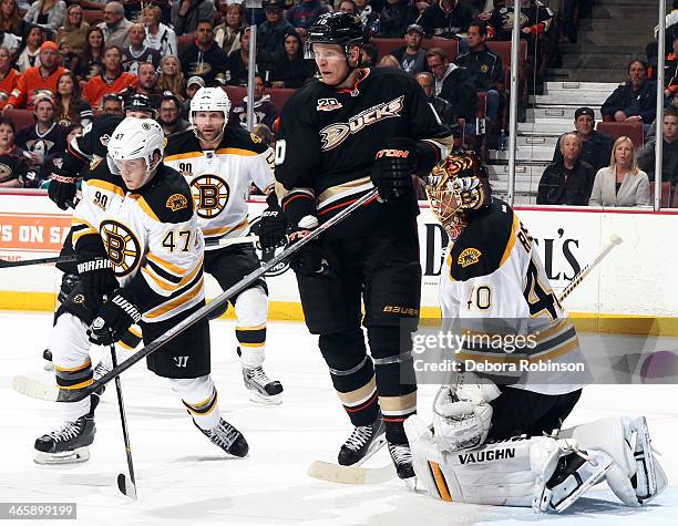 Corey Perry of the Anaheim Ducks skates against Torey Krug, Johnny Boychuk and Tuukka Rask of the Boston Bruins on January 7, 2014 at Honda Center in...