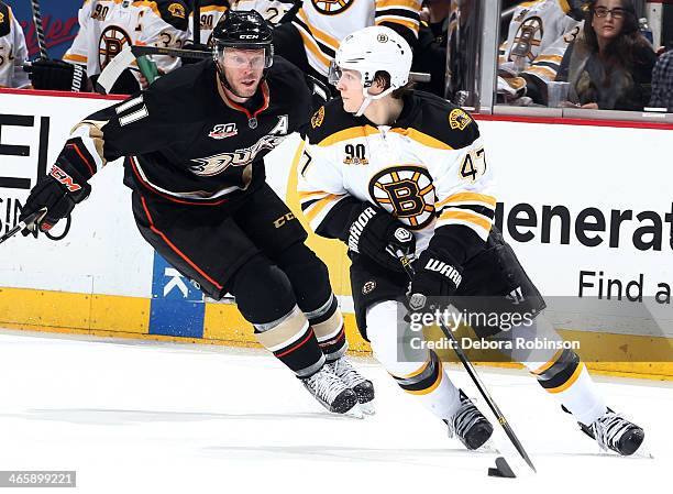 Torey Krug of the Boston Bruins handles the puck against Saku Koivu of the Anaheim Ducks on January 7, 2014 at Honda Center in Anaheim, California.