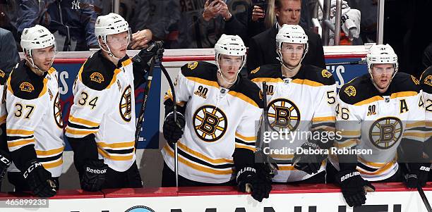 Patrice Bergeron, Carl Soderberg, Reilly Smith, Ryan Spooner and David Krejci of the Boston Bruins look on from the bench during the game against the...