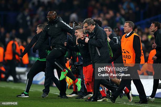 Laurent Blanc the head coach of PSG and his players celebrate following their team's victory in extra time during the UEFA Champions League Round of...