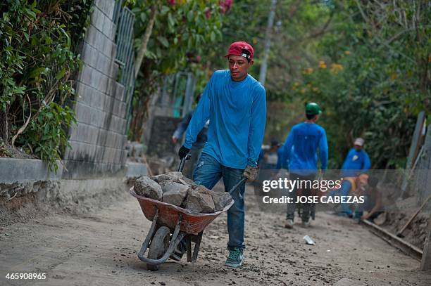 Members of the 18th street gang repair a street in the Granados neigborhood in the town of ILopango, 11 km east of San Salvador, on January 28 as...