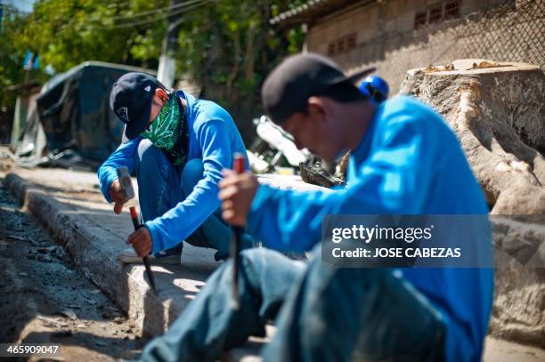 Members of the 18th street gang repair a street in the Granados neigborhood in the town of ILopango, 11 km east of San Salvador, on January 28 as...