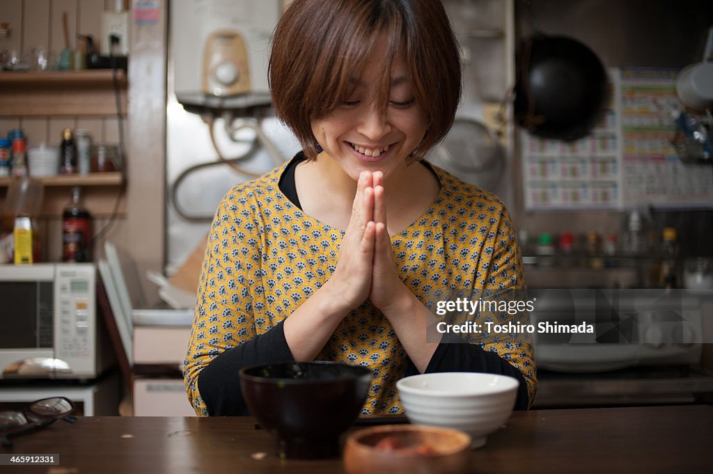 Japanese woman praying after eat