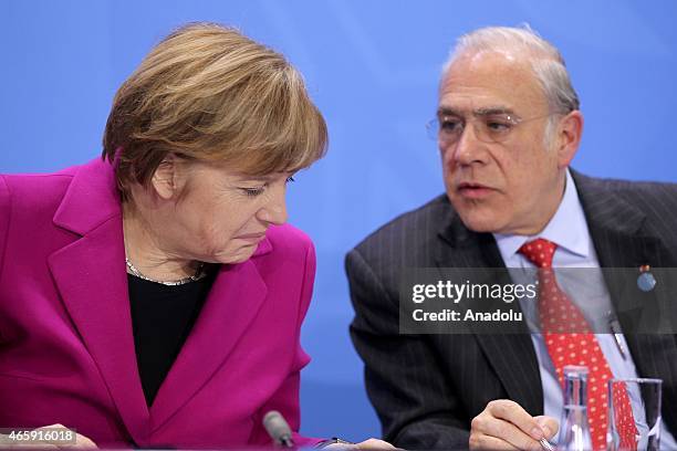 German Chancellor Angele Merkel and Secretary-General of the Organisation for Economic Co-operation and Development Jose Angel Gurria attend a press...