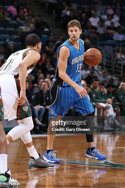 Luke Ridnour of the Orlando Magic defends the ball against the Milwaukee Bucks during the game on March 11, 2015 at BMO Harris Bradley Center in...