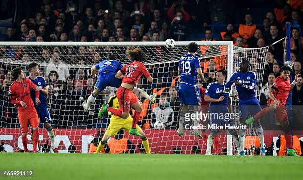 David Luiz of PSG rises above Branislav Ivanovic of Chelsea to score a goal past goalkeeper Thibaut Courtois of Chelsea to level the scores at 1-1...