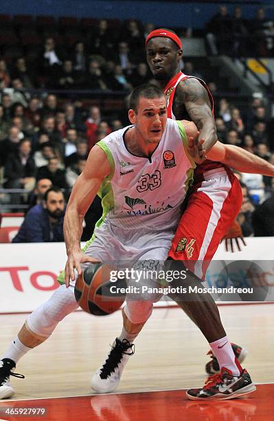 Nik Caner-Medley, #33 of Unicaja Malaga competes with Brent Petway, #4 of Olympiacos Piraeus during the 2013-2014 Turkish Airlines Euroleague Top 16...