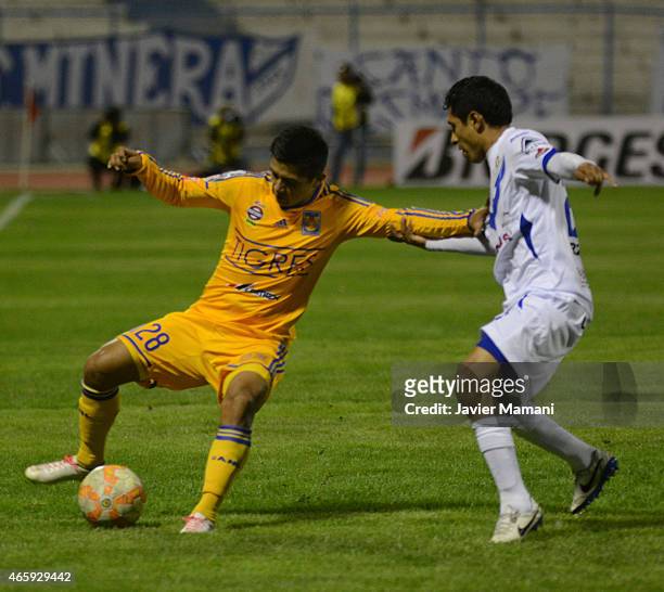 Dieter Villalpando of Tigres fights for the ball with Arnaldo Vera of San Jose during a match between San Jose Oruro and Tigres UANL as part of Copa...