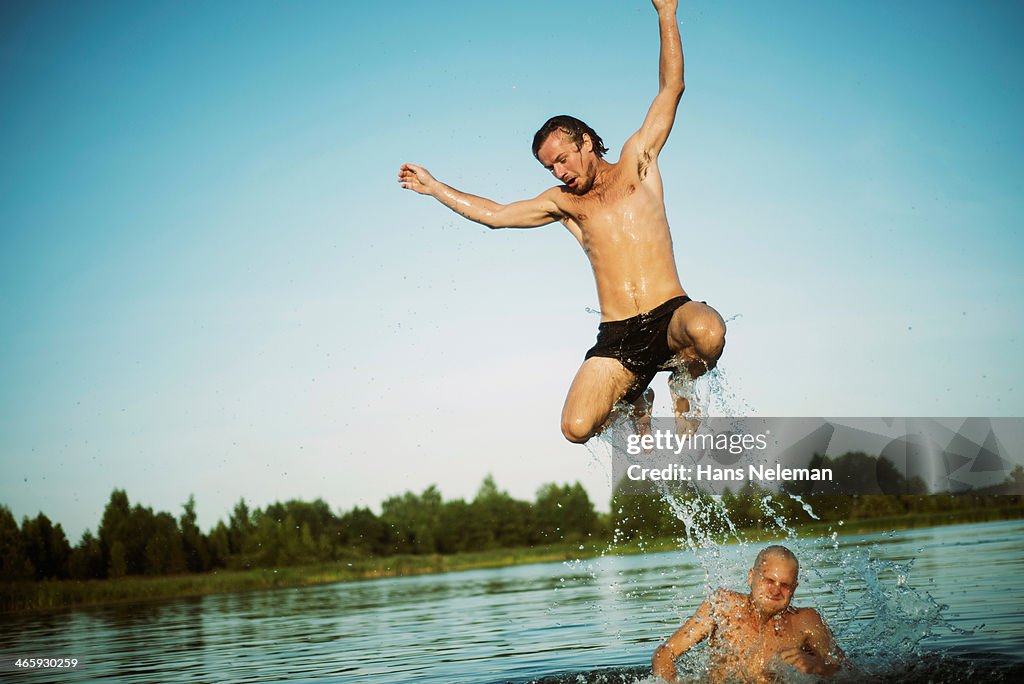 Men jumping into water