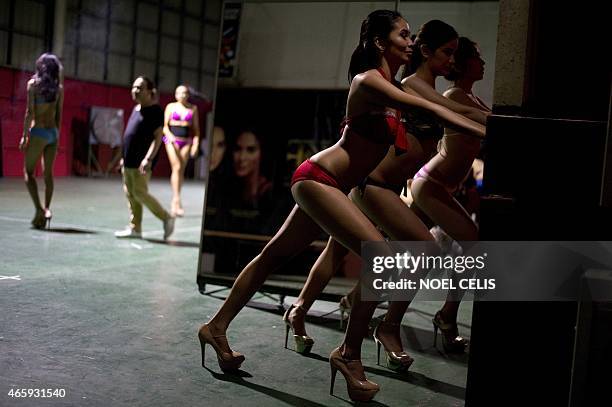 Philippines-beauty-lifestyle-poverty,FEATURE by Joel GUINTO Aspiring beauty queens stretches their legs at a beauty boot camp in Manila in this...