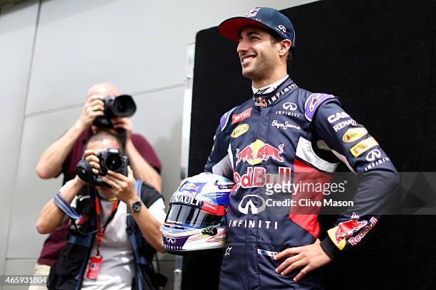 Daniel Ricciardo of Australia and Infiniti Red Bull Racing poses for photographers in the paddock during previews to the Australian Formula One Grand...