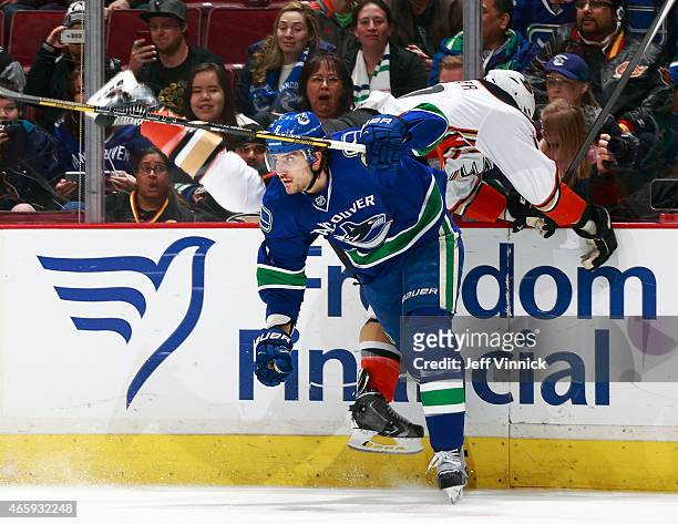 Christopher Tanev of the Vancouver Canucks checks Ryan Kesler of the Anaheim Ducks during their NHL game at Rogers Arena March 9, 2015 in Vancouver,...