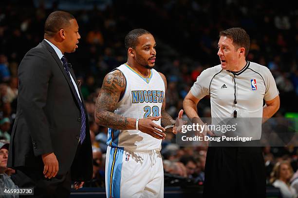 Jameer Nelson of the Denver Nuggets protests a call with referee Brent Barnaky as interim head coach Melvin Hunt of the Denver Nuggets leans in at...