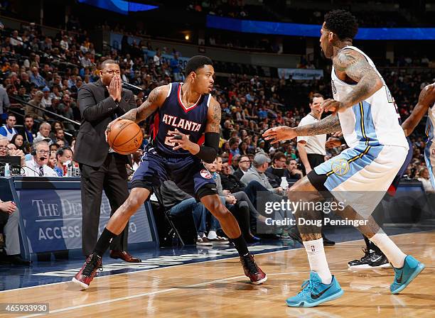 Interim head coach Melvin Hunt of the Denver Nuggets leads his team as Kent Bazemore of the Atlanta Hawks controls the ball against Wilson Chandler...