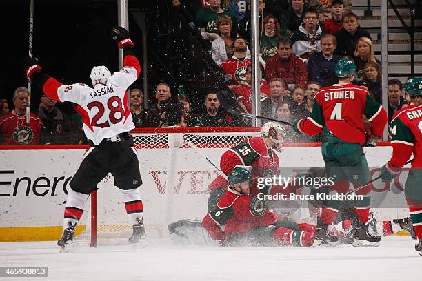 Matt Kassian celebrates after his Ottawa Senators teammate Erik Condra scores a goal with Marco Scandella, Darcy Kuemper, Clayton Stoner, and Mikael...