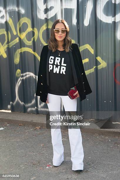 Aimee Song wears a 2 cent t shirt, J Brand jeans, and Oliver Peoples sunglasses on day 6 of Paris Collections: Women on March 08, 2015 in Paris,...