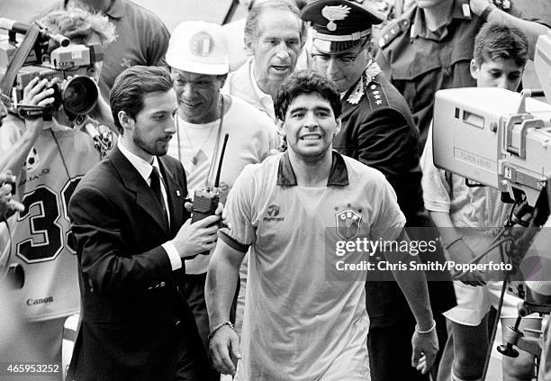 Diego Maradona of Argentina leaves the field wearing the shirt of Careca of Brazil after Argentina beat Brazil 1-0 in the Round of 16 during the FIFA...