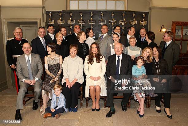 Catherine, Duchess of Cambridge poses with cast, crew and producers of Downton Abbey during an official visit to the set of Downton Abbey at Ealing...