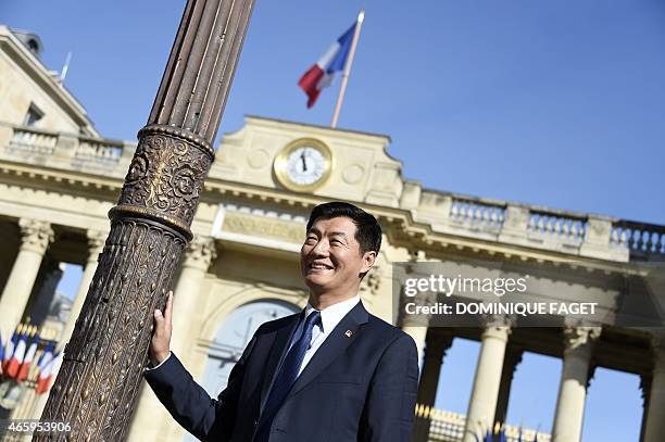 Lobsang Sangay, Sikyong of the Tibetan Government-in-Exile, poses in front of the French National Assembly on March 12, 2015 in Paris. AFP PHOTO /...