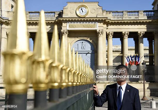 Lobsang Sangay, Sikyong of the Tibetan Government-in-Exile, poses in front of the French National Assembly on March 12, 2015 in Paris. AFP PHOTO /...